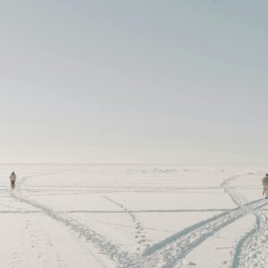 Photo of Persons Running on the Snow